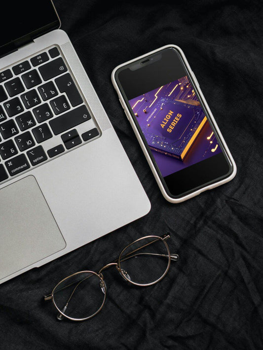 Laptop, smartphone with a 'Align Series' course, and eyeglasses on a dark surface